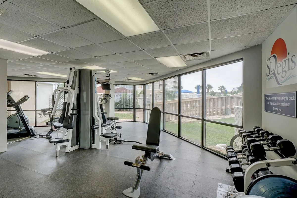 A bright, modern interior fitness center features an array of exercise equipment, large windows overlooking the resort's scenic exterior, and a welcoming, health-focused ambiance. The space is sunlit and inviting, encouraging wellness and active leisure.